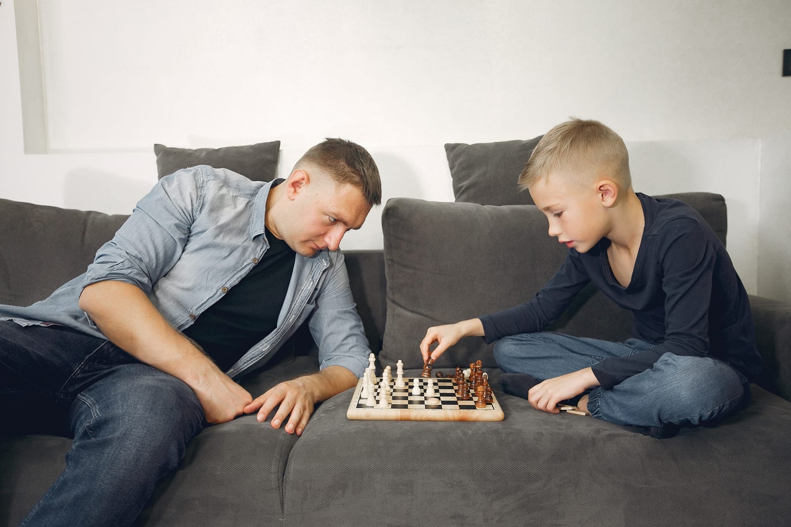 Pai e filho jogando xadrez juntos em uma partida de aprendizado